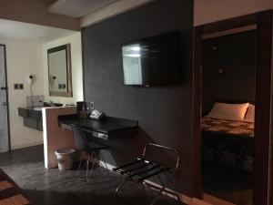 a hotel room with a desk and a bed at Hotel La Luna in Mexico City