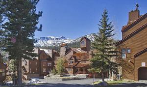 a group of buildings with a mountain in the background at Aspen Creek by 101 Great Escapes in Mammoth Lakes