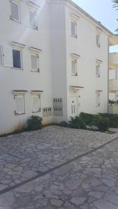 a white building with a lot of windows at Apartment Vesna in Novalja