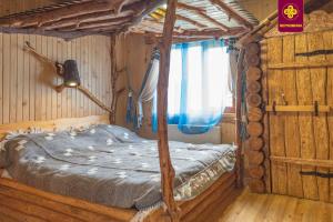 a bedroom with a bed in a wooden room at Плай in Verkhovyna