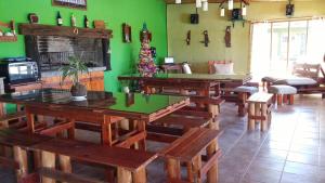 a restaurant with wooden tables and benches in a room at Cabañas Las Bahienses in San Rafael +50 photos