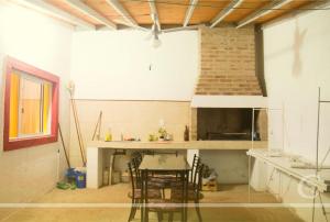 a kitchen with a table and chairs in a room at Cabañeros San Luis in San Roque