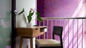 a desk with a plant and a chair in a room at Top Floor Bed and Breakfast in Paraparaumu Beach