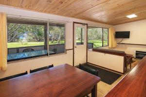 a conference room with a table and a large window at Siesta Park Holiday Resort ABSOLUTE BEACHFRONT RESORT in Busselton