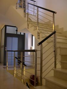 a staircase with a glass railing and a stair case at Baja delle Sirene in Taranto