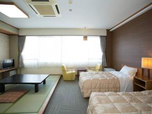 Katil atau katil-katil dalam bilik di Ikaho Grand Hotel