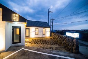 a building with a sign on the side of it at Wooyeon Handong Private Pension in Jeju