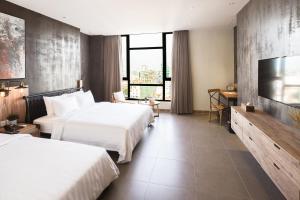 Postel nebo postele na pokoji v ubytování SIM Boutique Hotel