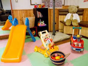 a childs play room with toys and a slide at Kagura White Horse Inn in Yuzawa
