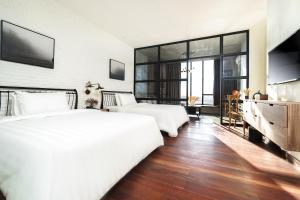 Postel nebo postele na pokoji v ubytování SIM Boutique Hotel