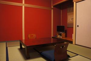 a dining room with a wooden table and a chair at Sumiyoshiya in Kanazawa