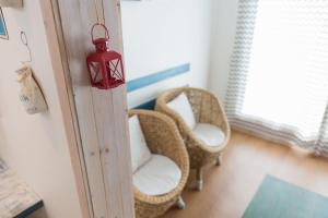 a room with wicker chairs and a lantern on the wall at 13 Ohoo in Namhae