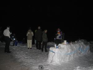 a group of people walking in the snow at night at Hinterankerwald in Walchsee