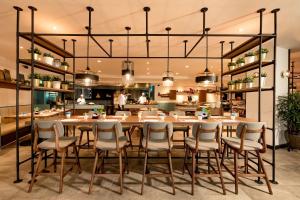 a kitchen filled with lots of tables and chairs at JEN Penang Georgetown by Shangri-La in George Town