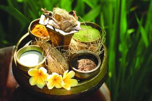 a group of plants sitting on a table with flowers at Bagus Jati Health & Wellbeing Retreat in Tegalalang
