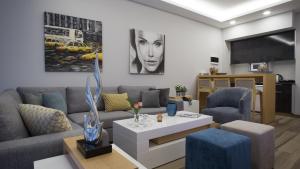 a living room with a couch and a table at The Stay Furnished Apartments in Dbayeh