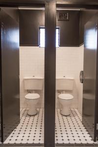 a public bathroom with two toilets in a stall at Nags Head Hotel in Newcastle