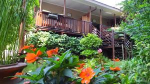 a garden with orange flowers in front of a house at Dublin Guest House in Sabie