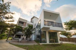 a large white building with a lot of windows at Okra Villa in Kenting