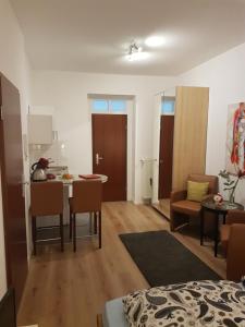 a living room with a kitchen and a dining room at Arkadenschlösschen Bonn in Bonn