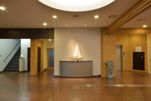 a lobby with a desk and a sail on the wall at Daini Prince Hotel Muroran View in Muroran +24 photos