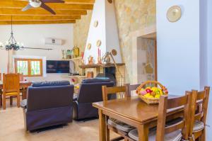 a dining room and living room with a table and chairs at Son Vanrell in Montuiri