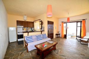 a bedroom with a bed with blue and white pillows at Koundouros Vacation Homes in Koundouros