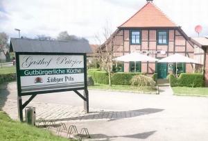 a sign in front of a building with a building at Gasthof Pritzier in Pritzier