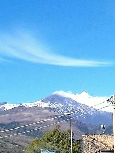 a snow covered mountain in the distance at Bed Relax Etnaview Self check-in in Zafferana Etnea