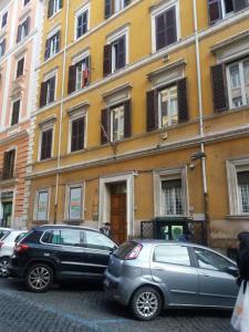 ローマにあるFEDERICA'S APARTMENT IN ROMEの建物の前に駐車した車両2台