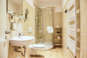 a bathroom with a toilet and a sink and a shower at City Residence Hotel Frankfurt-Oder Bahnhof in Frankfurt/Oder +133 photos