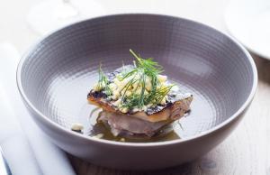 a white bowl with food in it on a table at The Swan Hotel in Southwold