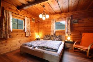 a bedroom with a bed in a log cabin at Almliesl RAUR-521 in Rauris