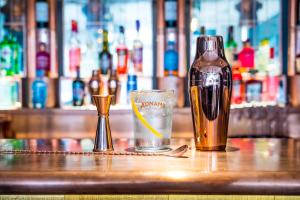 a bottle of wine and a glass on a bar at The Swan Hotel in Southwold
