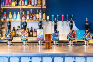 a group of bottles of beer on a bar at The Swan Hotel in Southwold