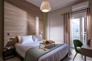 a hotel room with a bed with a table on it at Downtown Central Apartments in Heraklio