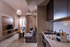 a kitchen and living room with a couch and a table at Downtown Central Apartments in Heraklio