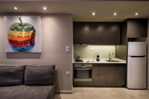a kitchen with a painting of an apple on the wall at Downtown Central Apartments in Heraklio