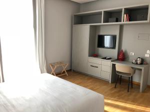 A bed or beds in a room at 200 ROOMS & TERRACE