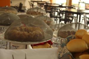 a table with two trays of muffins on top at Hotel Michelangelo in Sao Jose do Rio Preto