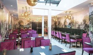 a dining room with purple chairs and tables at Thon Hotel Spectrum in Oslo