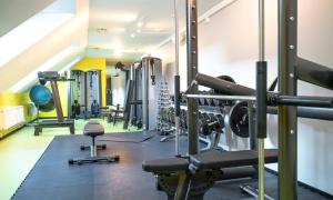 a gym with several treadmills and machines at Thon Hotel Spectrum in Oslo