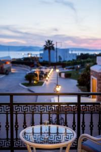 a table on a balcony with a view of a street at Plaza Beach Hotel in Plaka