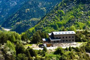 a building on the side of a mountain at Hostal Parque Natural in Benasque