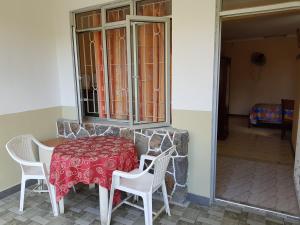 a table and two chairs and a table and a window at Pereybere Beach Apartments in Pereybere