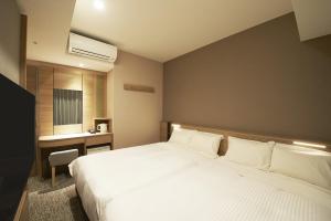 Postel nebo postele na pokoji v ubytování Sotetsu Fresa Inn Tokyo Kanda