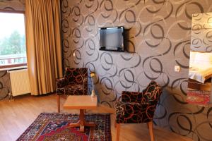Habitación con 2 sillas y TV en la pared. en Hotel Ipekyolu en Estambul