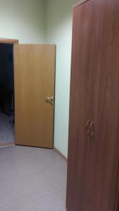 a door leading to a room with a wooden floor at Hotel Sultanmurat in Almetyevsk
