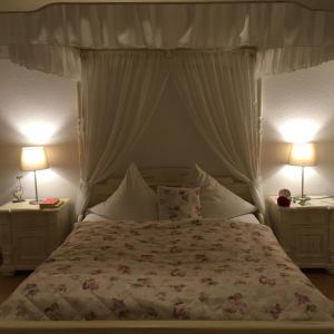 a bedroom with a large bed with two night stands at Hotel Alt Annaberg in Annaberg-Buchholz