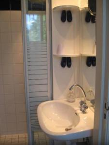 a bathroom with a white sink and a shower at Suite 17 in Eindhoven